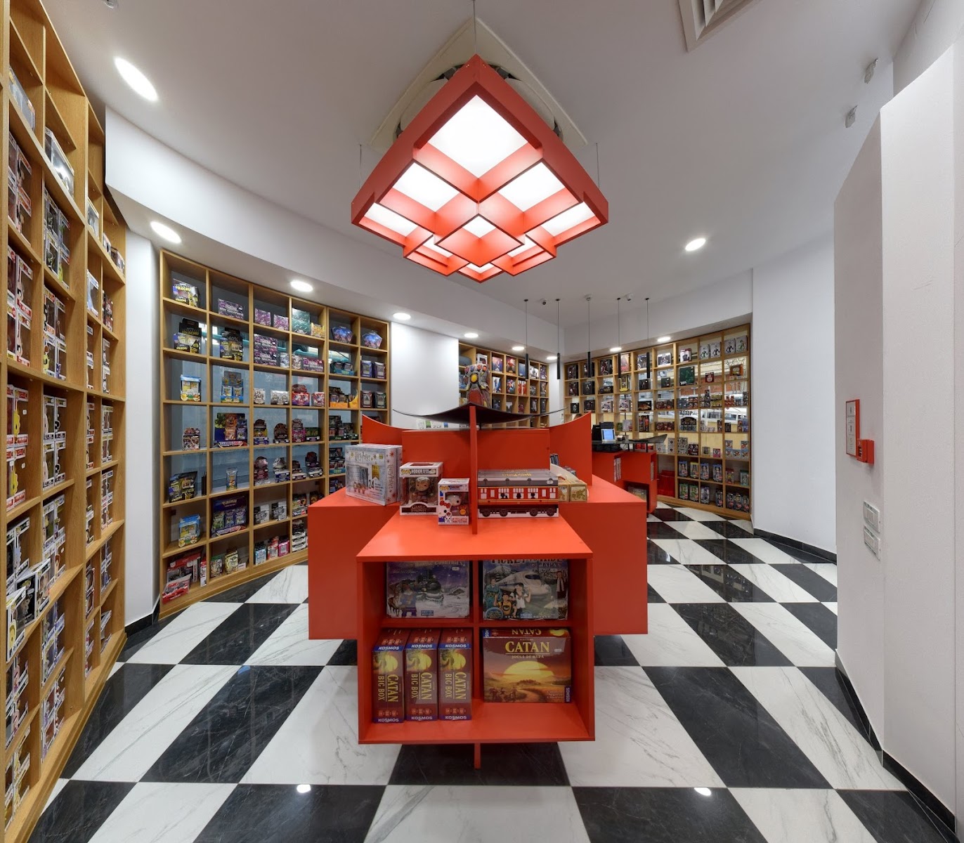 Board game room with curved shelves and a bright red Catan display table